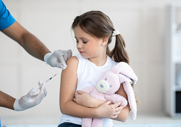 Little girl getting a shot in her arm