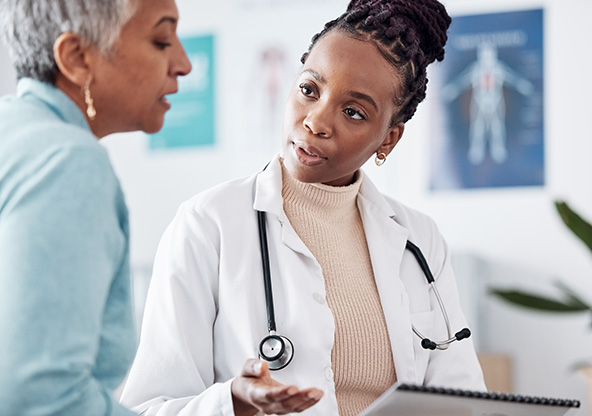 A young doctor talks to her patient
