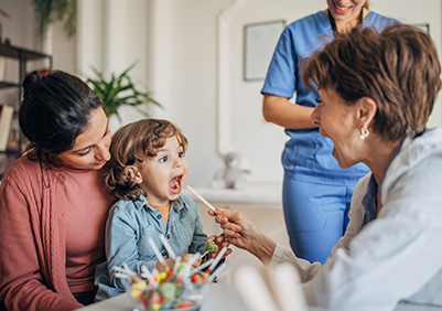 Using a tonggue depressor to view the back of a child's throat