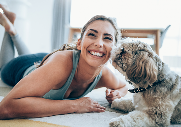 A woman with her dog who has a parathyroid disorder